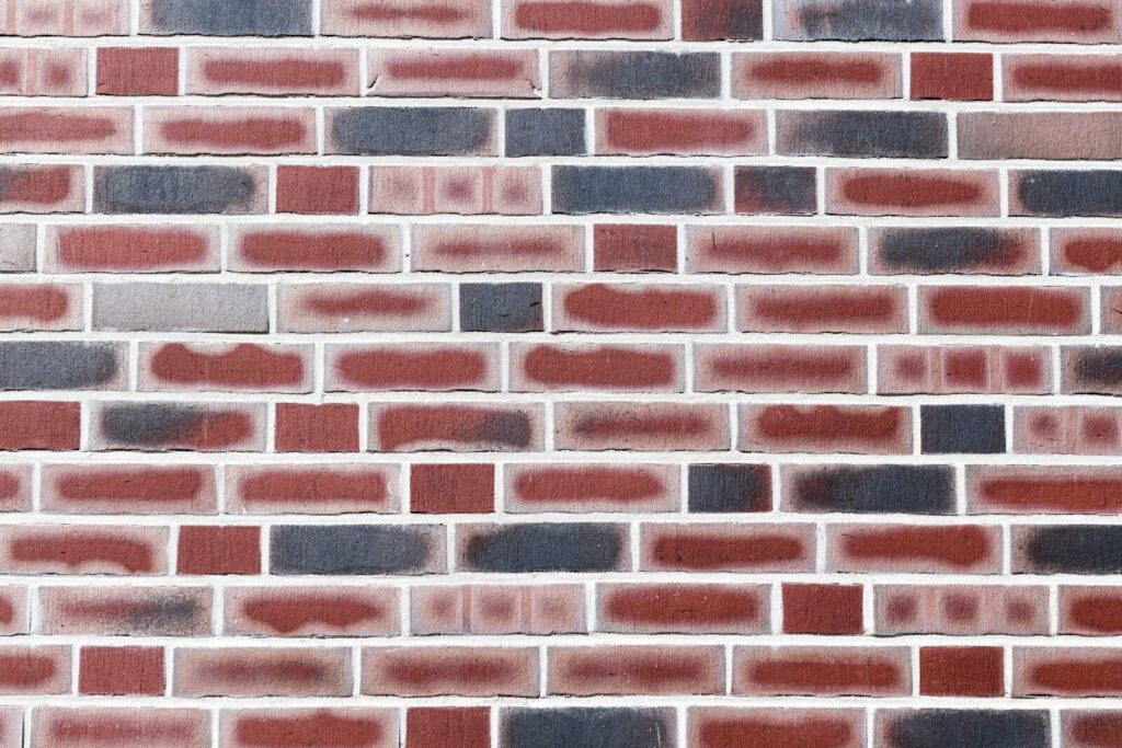 A close-up view of a colorful brick wall.